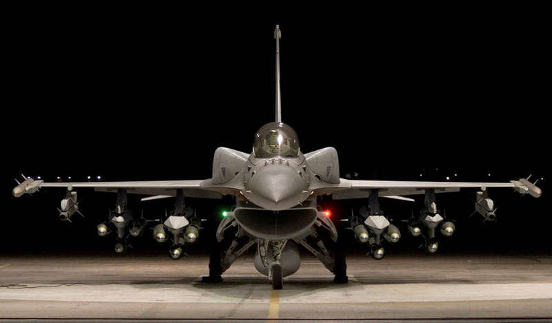 The F-16V/Block 70. Note conformal fuel tanks on upper fuselage. The aircraft is also equipped with a centerline fuel tank, twelve satellite guided bombs, two AIM-120 AMRAAM radar-guided air to air missiles, and two AIM-9X Sidewinder missiles.